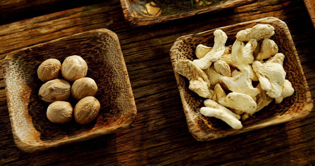 Wooden bowls with nuts on a rustic table highlight a wholesome, organic snack contrast. - Free Images, Stock Photos and Pictures on Pikwizard.com