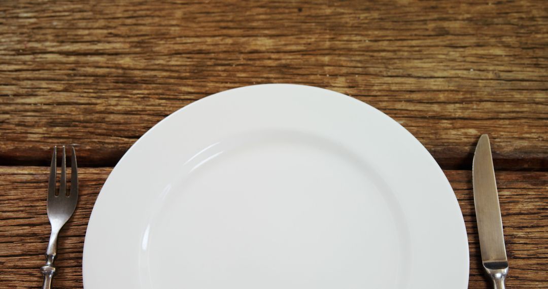 Empty White Plate with Fork and Knife on Wooden Table Background - Free Images, Stock Photos and Pictures on Pikwizard.com