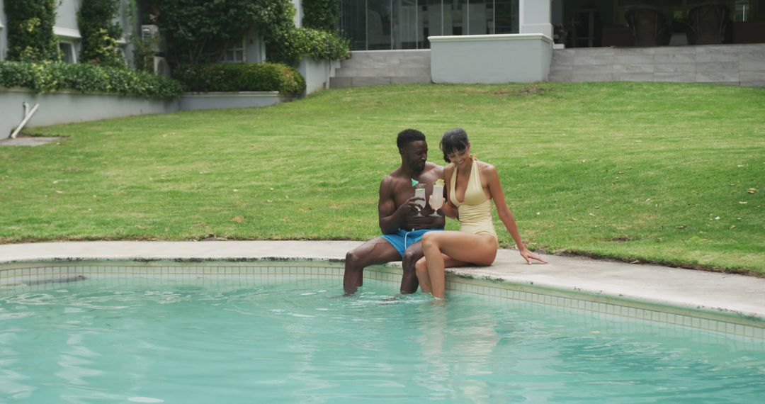 Diverse Couple Relaxing by Poolside with Refreshing Drinks