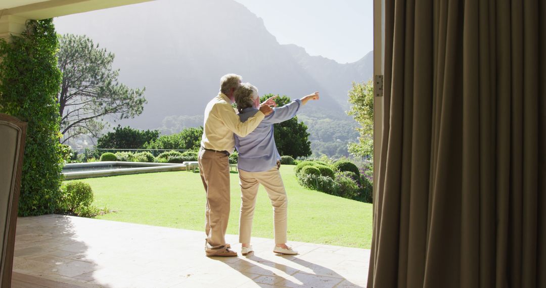 Rear view of caucasian senior couple pointing towards a directing standing near the garden - Free Images, Stock Photos and Pictures on Pikwizard.com