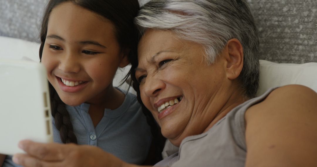 Grandmother and Granddaughter Taking Selfie Together and Smiling - Free Images, Stock Photos and Pictures on Pikwizard.com