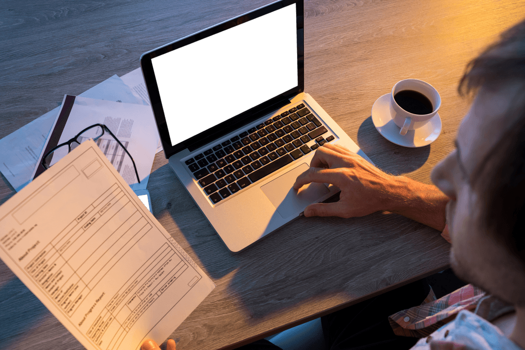 Male Executive with Transparent Screen Laptop Working Late at Office