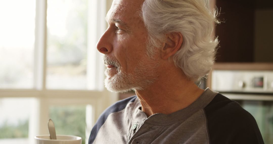 Senior Man Enjoying Coffee in Kitchen at Sunrise - Free Images, Stock Photos and Pictures on Pikwizard.com