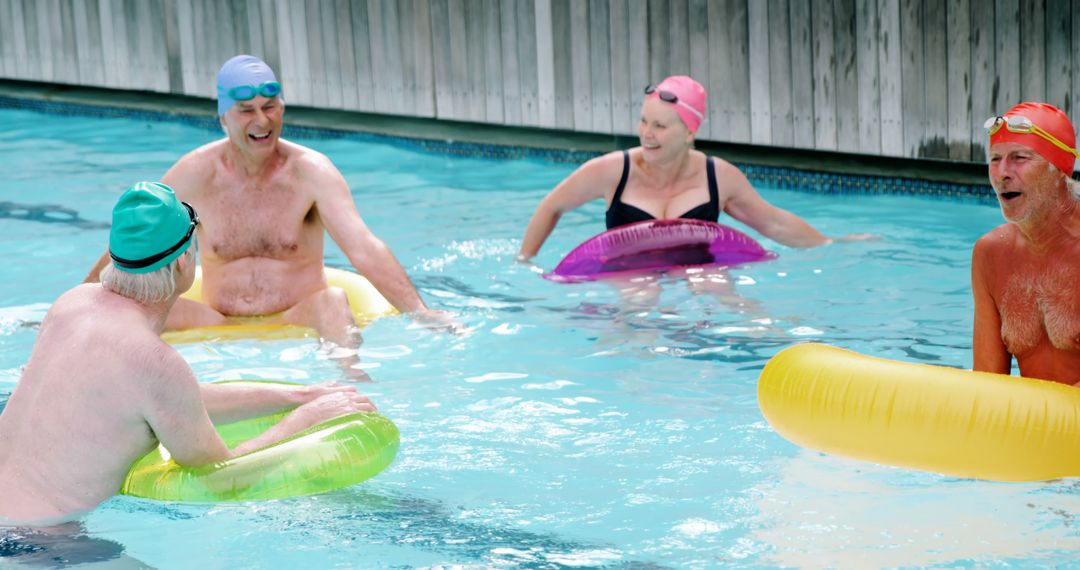 Seniors Enjoying Pool Time with Colorful Swim Caps - Free Images, Stock Photos and Pictures on Pikwizard.com