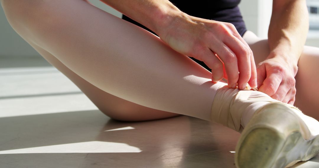 Ballerina wearing ballet shoes in the studio - Free Images, Stock Photos and Pictures on Pikwizard.com