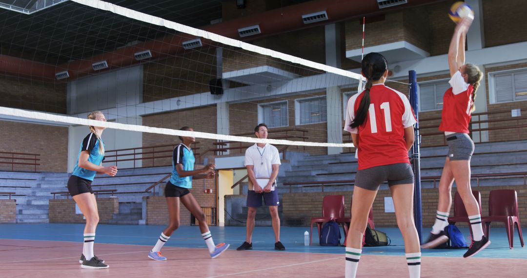 Girls Volleyball Team Playing Competitive Match Indoors - Free Images, Stock Photos and Pictures on Pikwizard.com