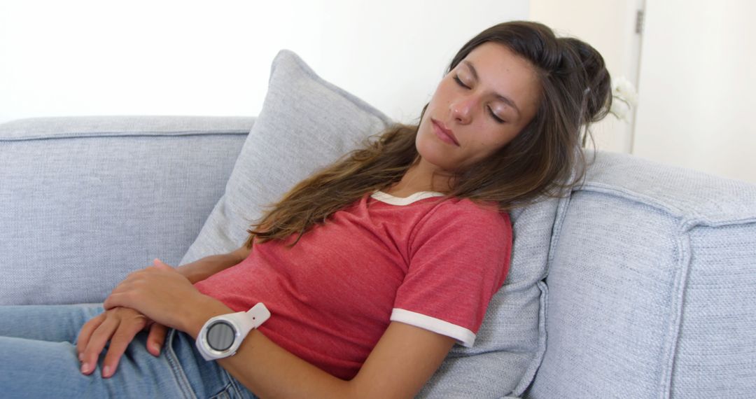 Young Woman Relaxing with Eyes Closed on Sofa in Casual Wear - Free Images, Stock Photos and Pictures on Pikwizard.com