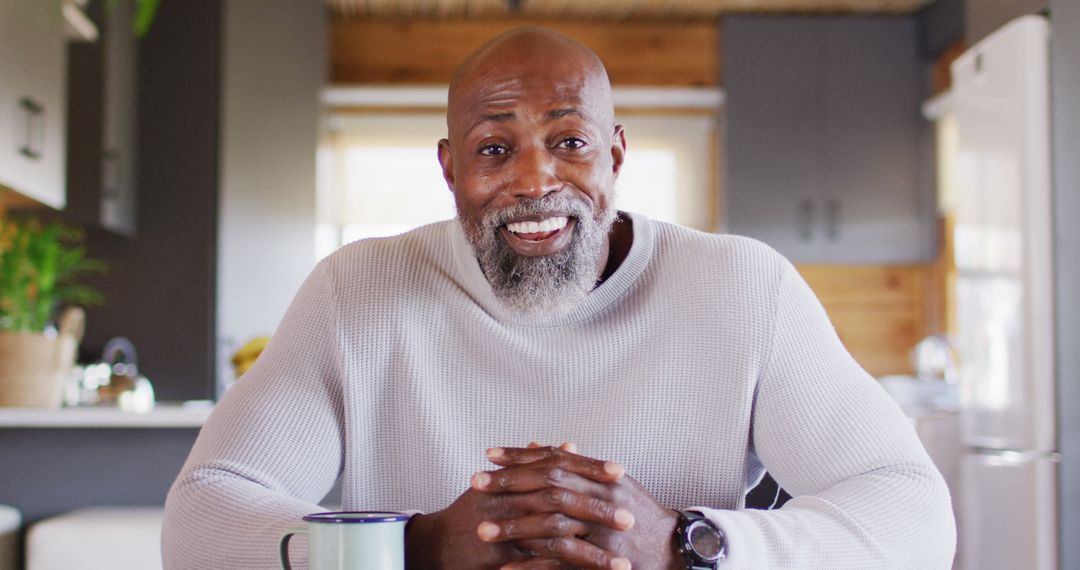 Smiling Mature African American Man Sitting at Home - Free Images, Stock Photos and Pictures on Pikwizard.com