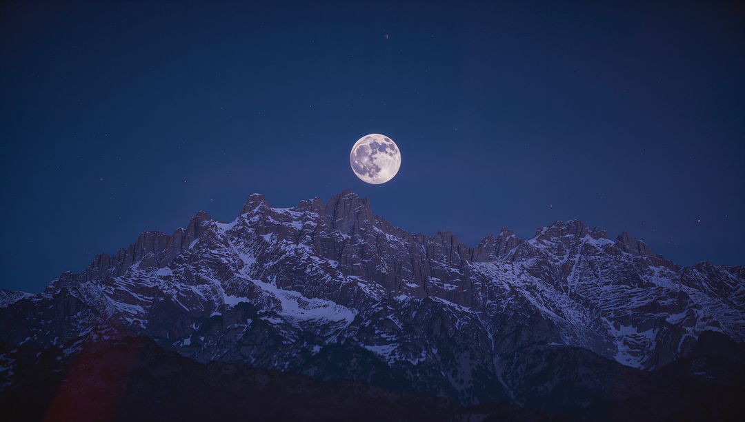 Full Moon Illuminating Alpine Mountain Peaks