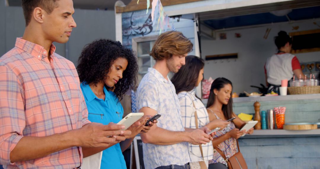 Diverse Group of Friends Using Smartphones in Line at Food Truck - Free Images, Stock Photos and Pictures on Pikwizard.com