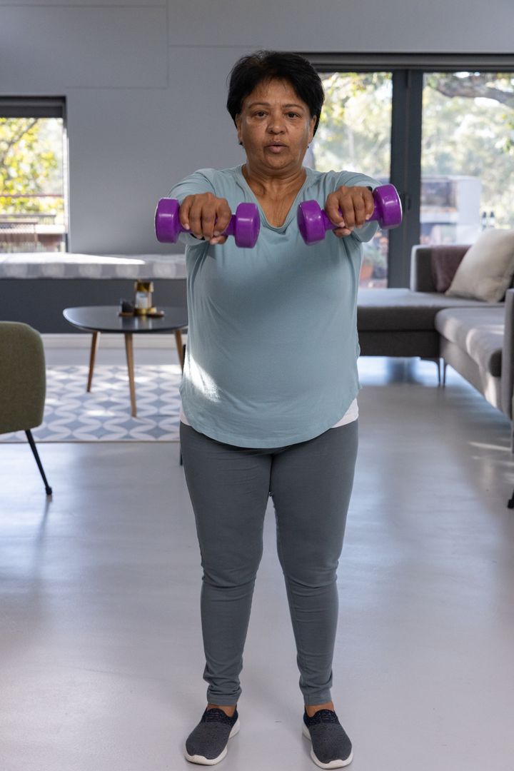 Senior Indian Woman Exercising with Dumbbells at Home