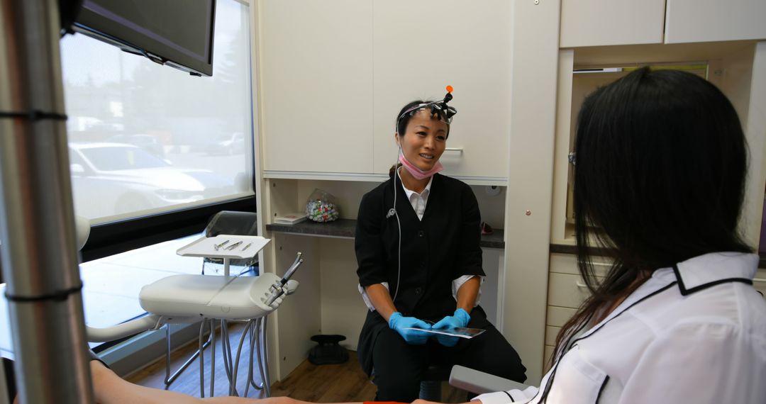 Dentist Consults Patient in Modern Dental Clinic - Free Images, Stock Photos and Pictures on Pikwizard.com