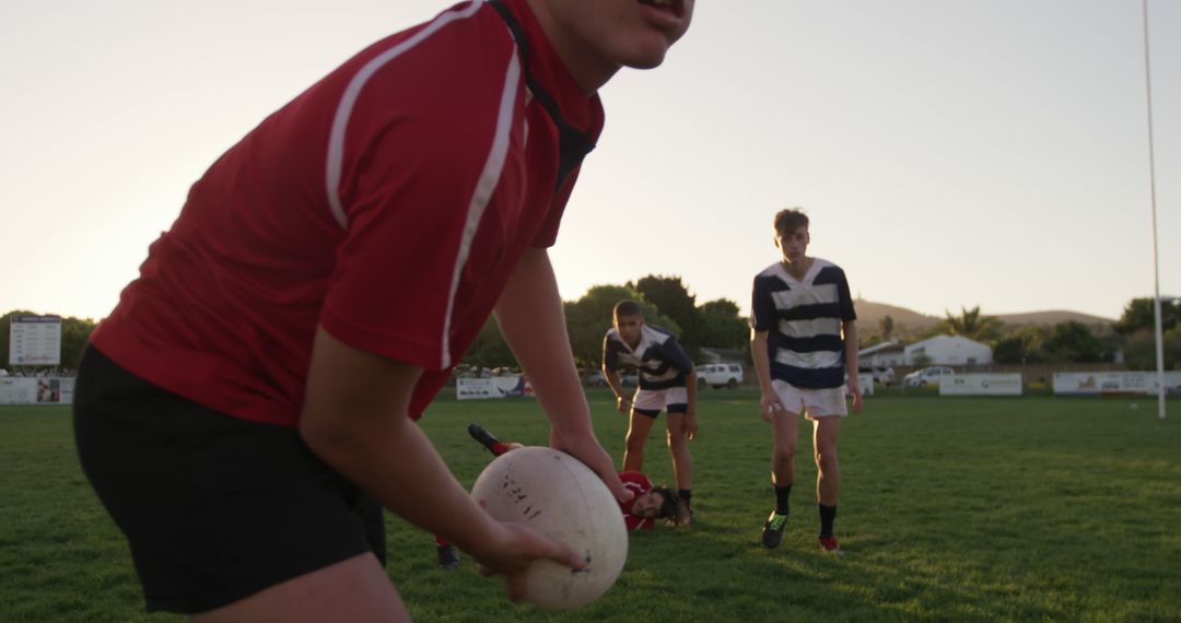 Rugby Players Competing on Field During Sunset - Free Images, Stock Photos and Pictures on Pikwizard.com