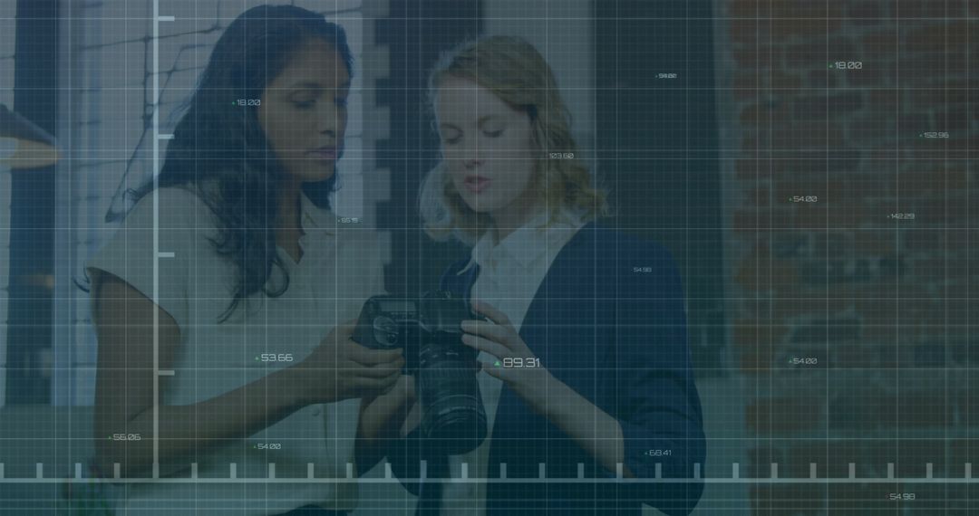 Women Analyzing Camera Settings with Digital Financial Overlay