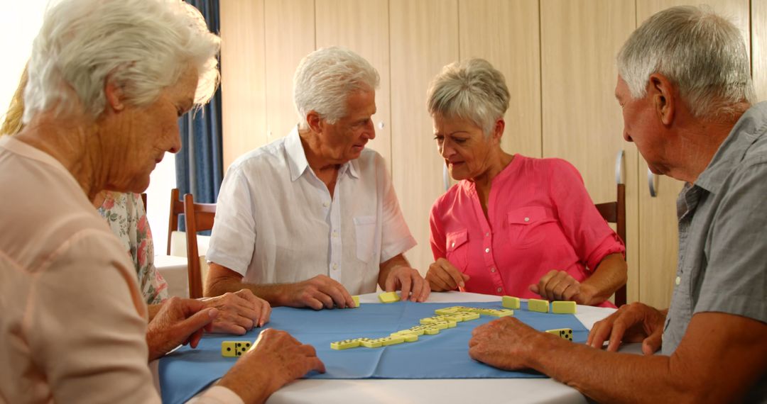 Elderly Friends Enjoying a Game of Dominoes Together - Free Images, Stock Photos and Pictures on Pikwizard.com