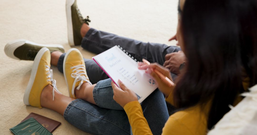 Couple Planning Vacation Journey Adventures with Itinerary Notebook