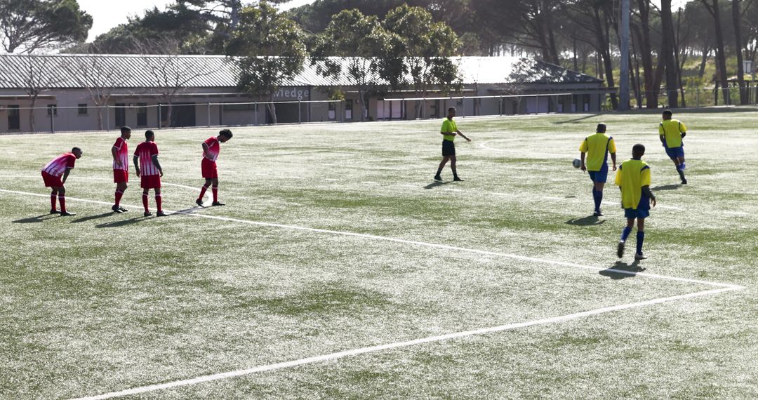 Youth Soccer Players Competing on Field Under Sunny Sky
