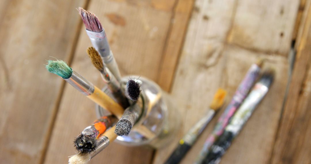 Assorted Paintbrushes in Glass Jar on Rustic Wooden Table - Free Images, Stock Photos and Pictures on Pikwizard.com