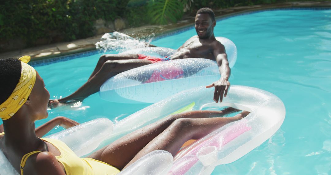 Couple Enjoying Relaxing Pool Floatation on a Sunny Day - Free Images, Stock Photos and Pictures on Pikwizard.com