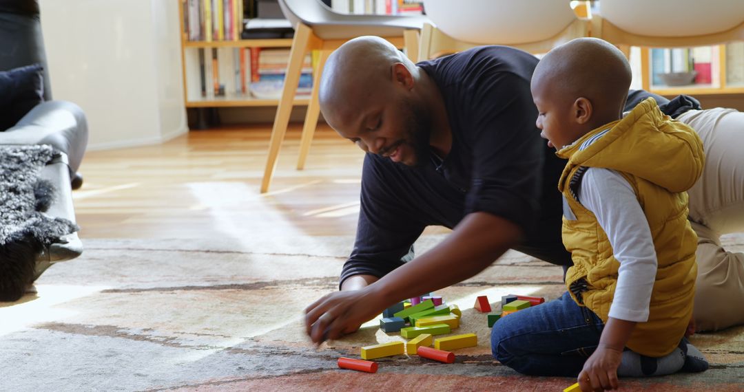 African American Father and Son Play with Building Blocks at Home