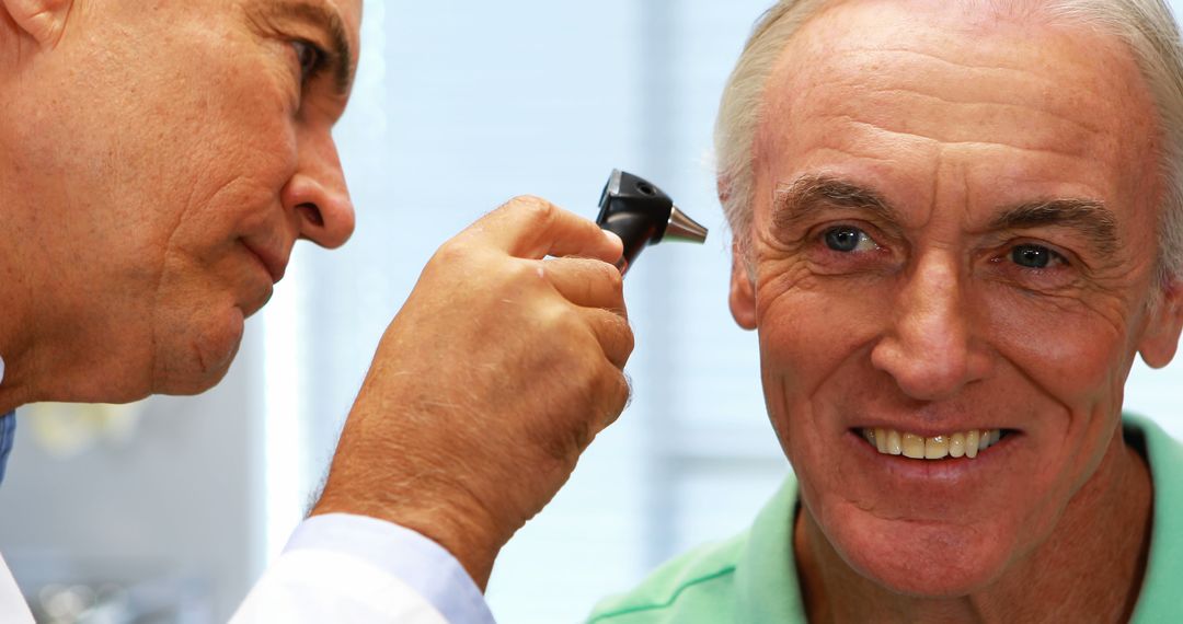 Doctor examining senior patient's ear in medical clinic - Free Images, Stock Photos and Pictures on Pikwizard.com