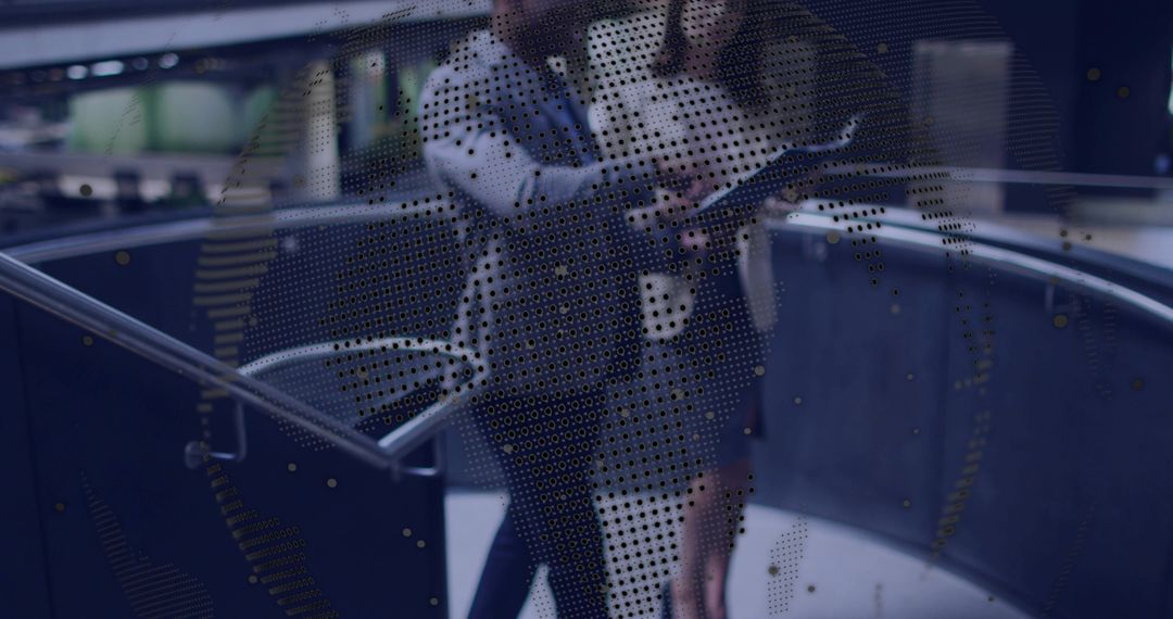 Walking and collaborating with tablet in modern atrium through perforated globe display