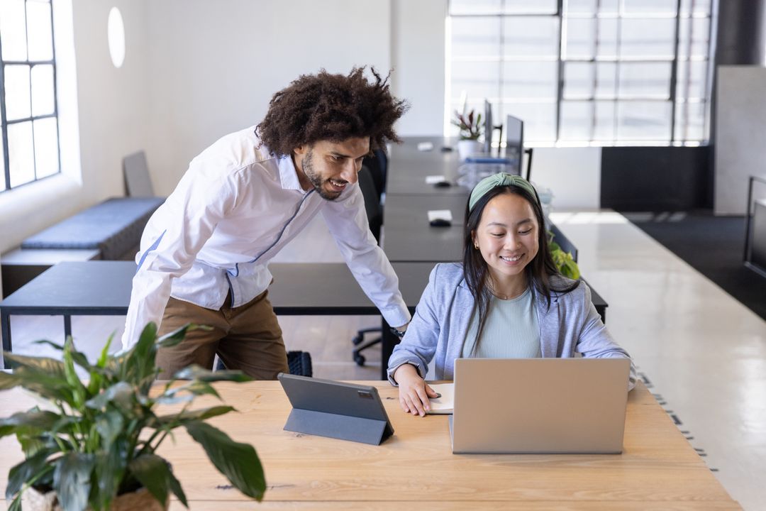 Diverse Coworkers Collaborating in Open-Plan Office Environment