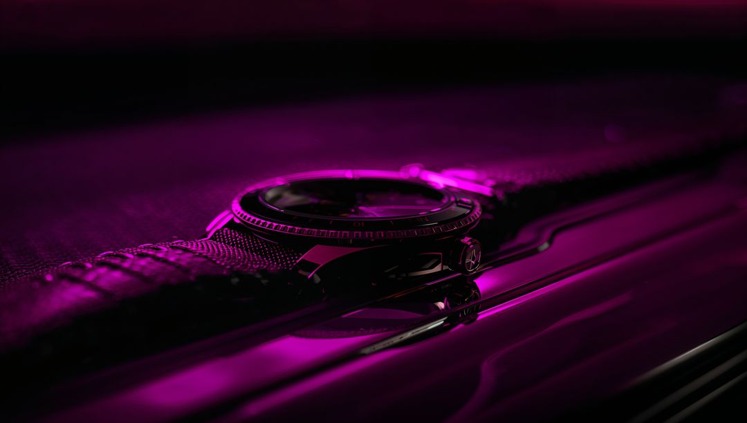 Moody Magenta Watch Close-Up on Reflective Surface with Woven Strap and Bezel Detail