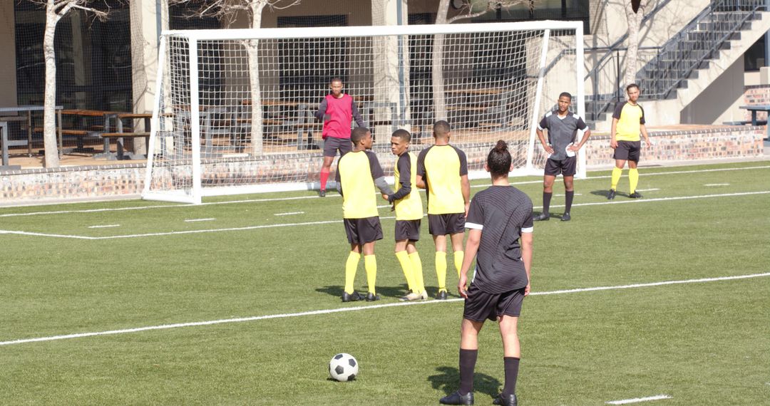 Soccer Players Practicing Free Kick on Sunny Field