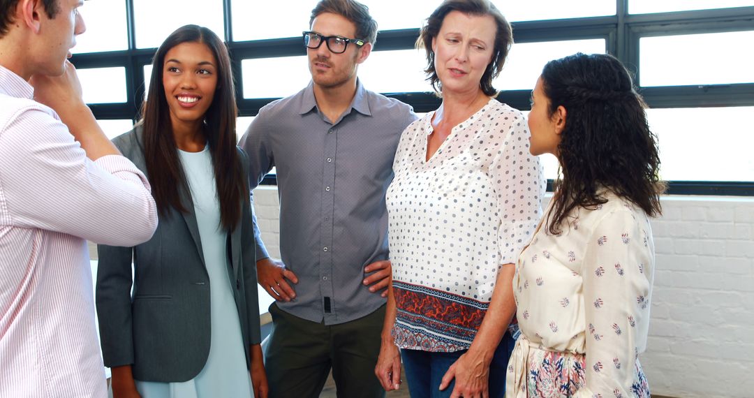 Diverse Business Team Engaged in Lively Office Discussion