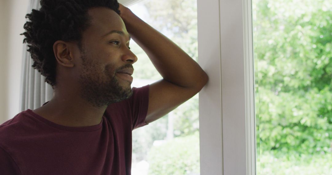 Thoughtful Man Observing Nature through Window