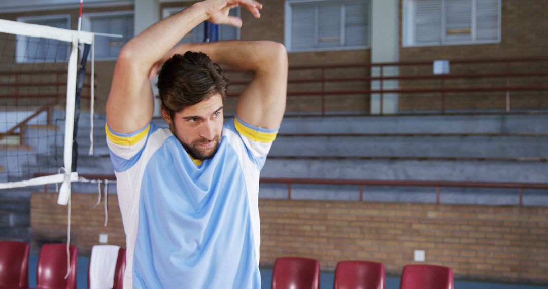 Athletic Man Stretching Arms in Indoor Volleyball Court - Free Images, Stock Photos and Pictures on Pikwizard.com