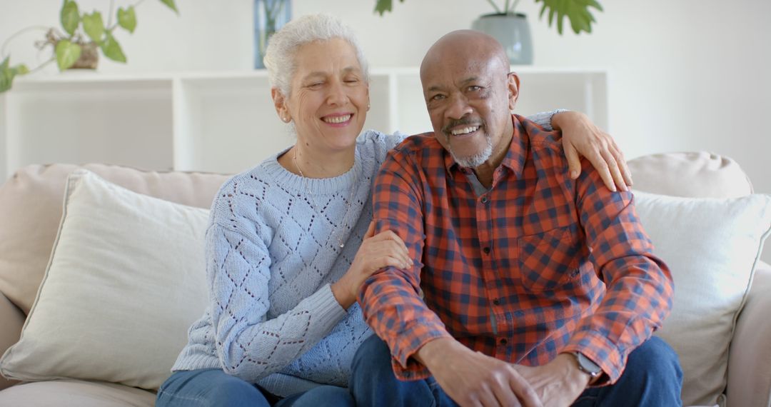 Smiling Senior Couple Relaxing on Couch at Home - Free Images, Stock Photos and Pictures on Pikwizard.com