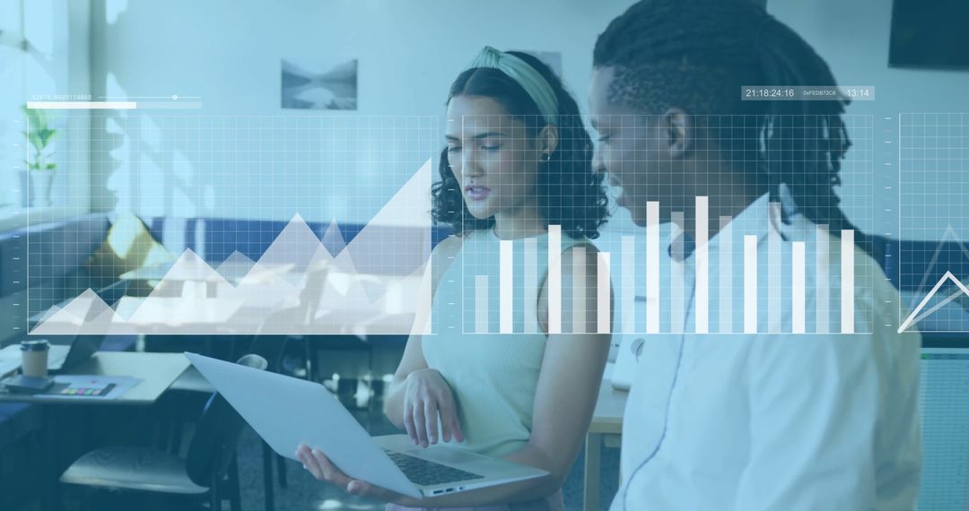 Business Colleagues Analyzing Data on Laptop with Financial Charts Overlay