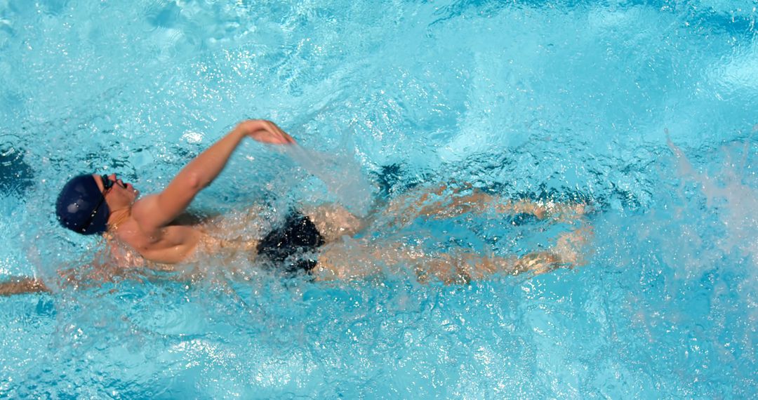 Male Swimmer Performing Backstroke in Clear Blue Pool - Free Images, Stock Photos and Pictures on Pikwizard.com