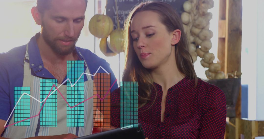 Farmers Market Vendors Analyzing Sales Data on Tablet