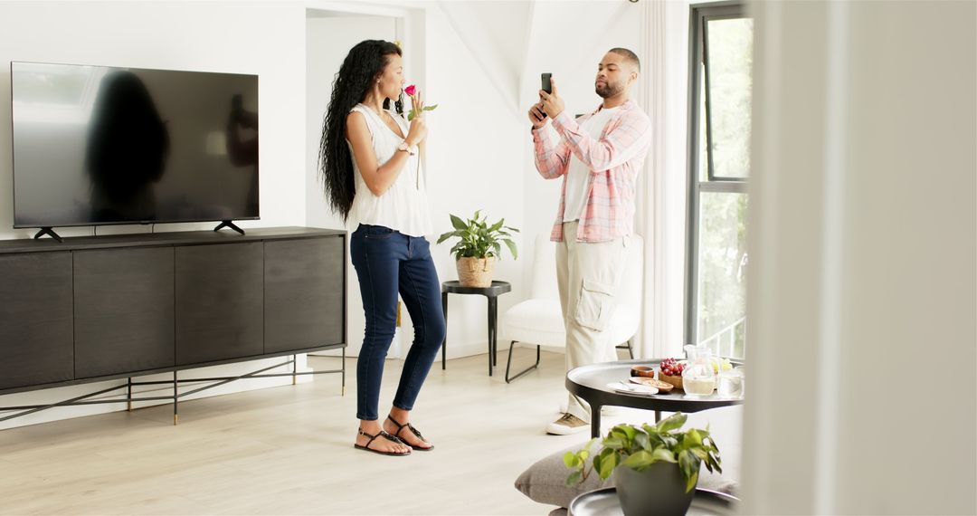 Couple Celebrating Engagement with Photos and Rose at Home