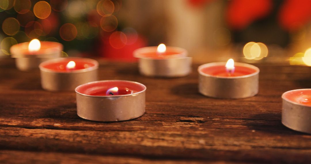 Tealight candles burning on wooden table 4k - Free Images, Stock Photos and Pictures on Pikwizard.com