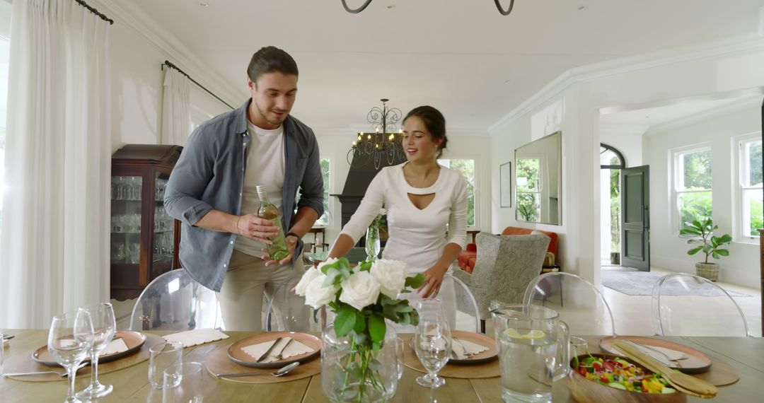 Smiling Couple Setting Dining Table for Intimate Gathering at Home
