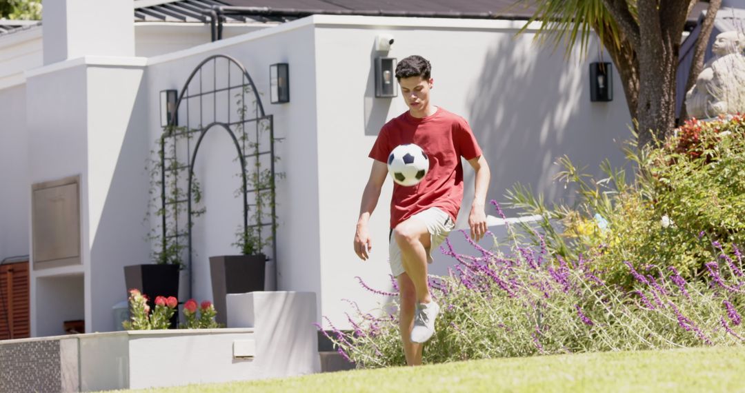 Teen Practicing Soccer Skills in Backyard on Sunny Day