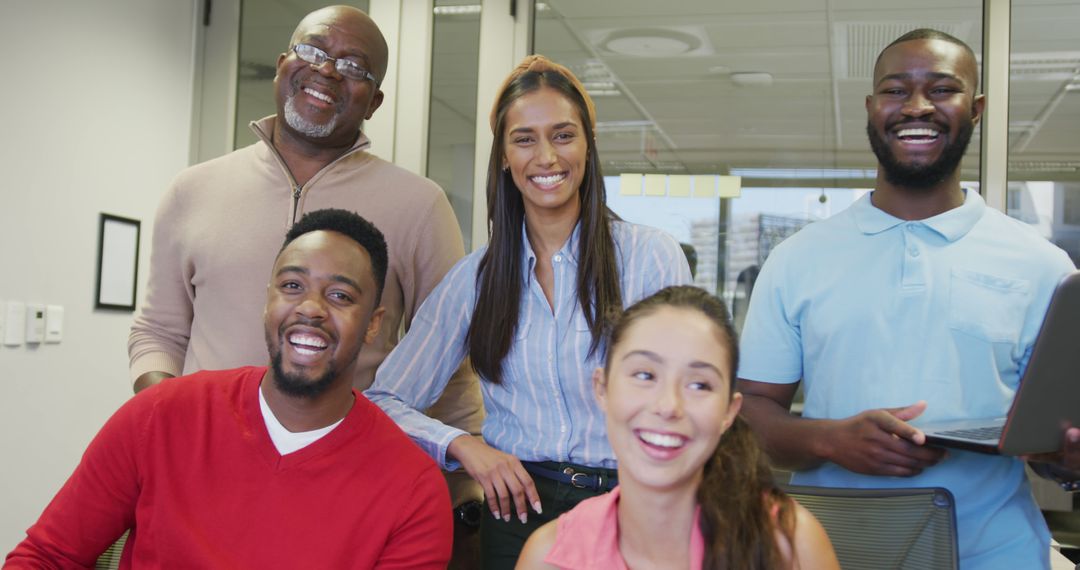 Diverse Team of Professionals Smiling in Modern Office Environment - Free Images, Stock Photos and Pictures on Pikwizard.com