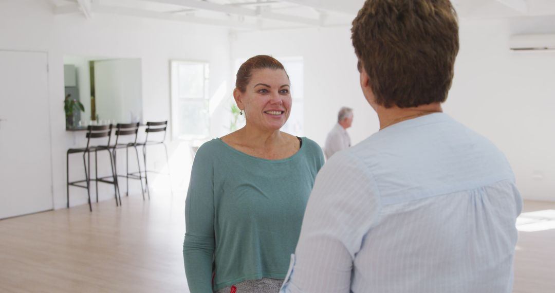 Two Middle-aged Women Having Conversation in Bright Modern Room - Free Images, Stock Photos and Pictures on Pikwizard.com