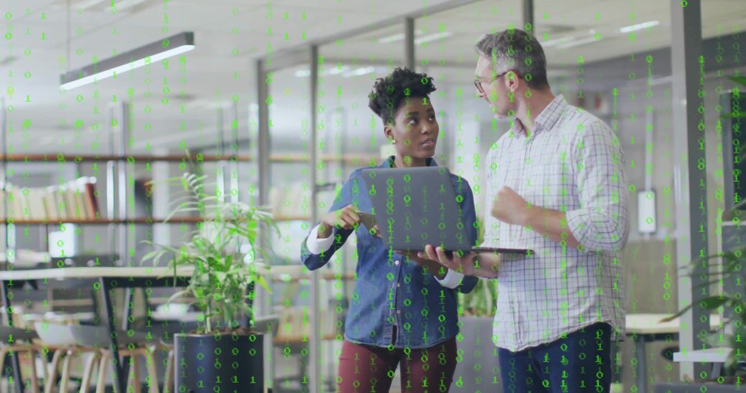 Colleagues Collaborating in Modern Office with Binary Code Overlay
