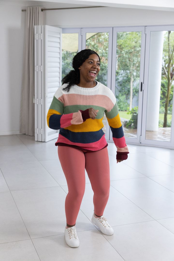 Active Woman Enjoying Home Workout in Bright Indoor Space