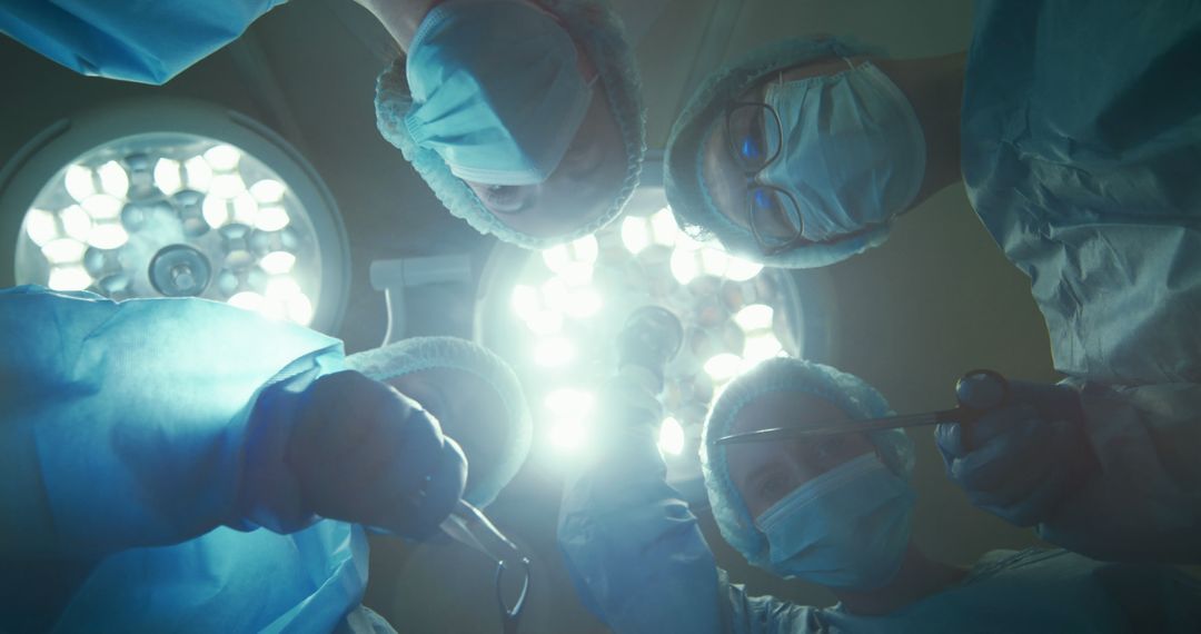 Surgical Team Performing Operation Under Bright Lights - Free Images, Stock Photos and Pictures on Pikwizard.com
