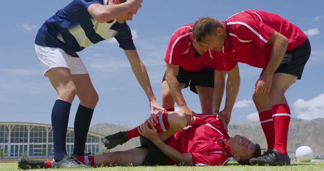 Soccer Players Helping Injured Teammate on Field - Free Images, Stock Photos and Pictures on Pikwizard.com