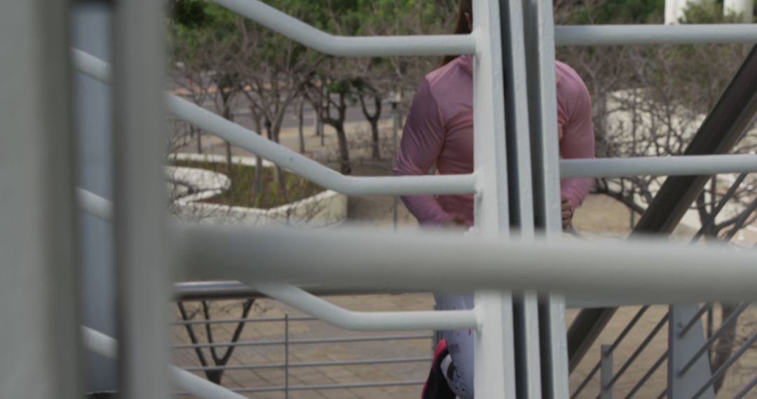 Person Running on Outdoor Staircase with Metal Railings - Free Images, Stock Photos and Pictures on Pikwizard.com