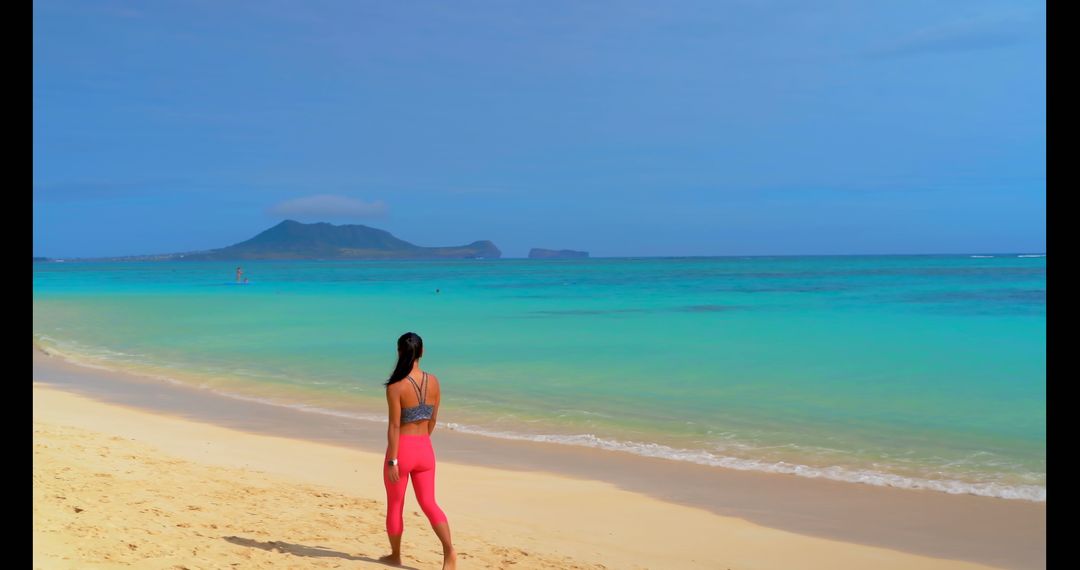 Woman in Pink Leggings Standing on Sunny Tropical Beach - Free Images, Stock Photos and Pictures on Pikwizard.com