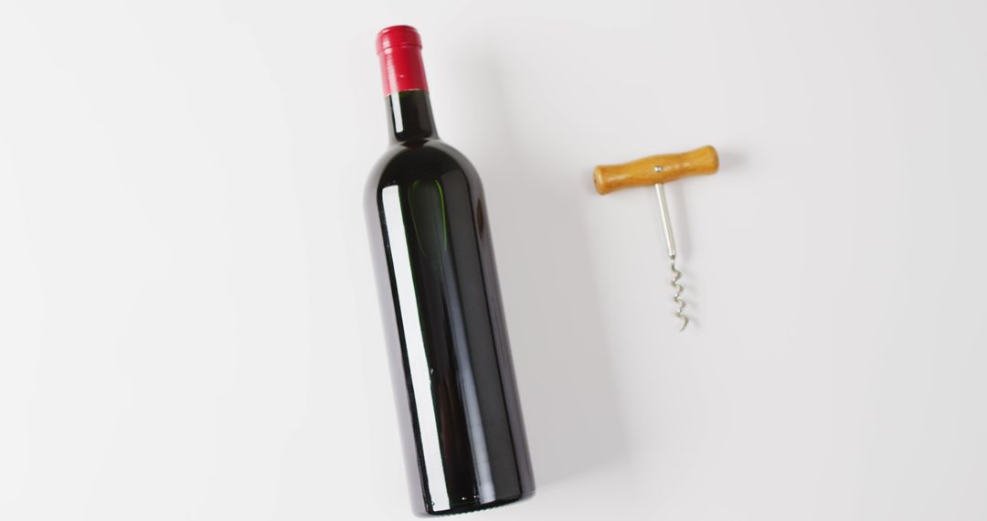 Red Wine Bottle with Corkscrew on White Background