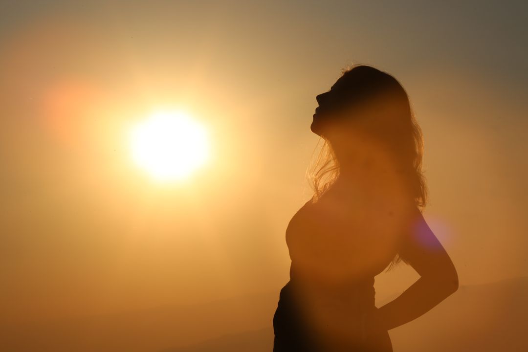 Silhouette of Woman at Sunset with Bright Sunlight - Free Images, Stock Photos and Pictures on Pikwizard.com